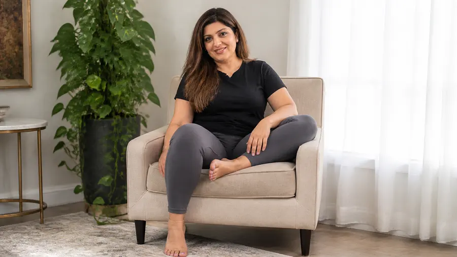 gpt-image-2 render: A South Asian woman aged 30, naturally curvy body, sitting on a chair. Full body in the frame. wi...